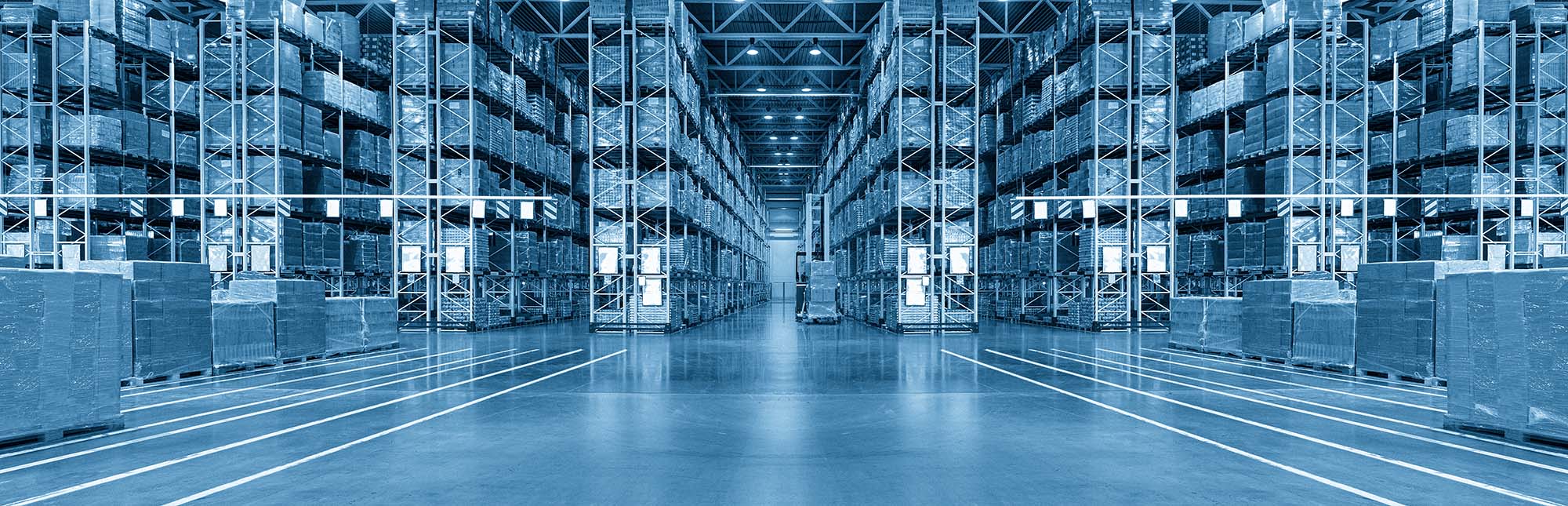 Industrial warehouse with tall shelving and a blue overlay, used as a hero image for Master Blasterz cleaning services.